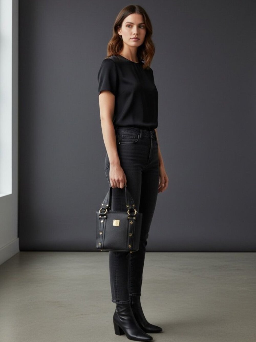 Black pebbled leather MCM Munchen studded satchel tote bag with gold-plated hard